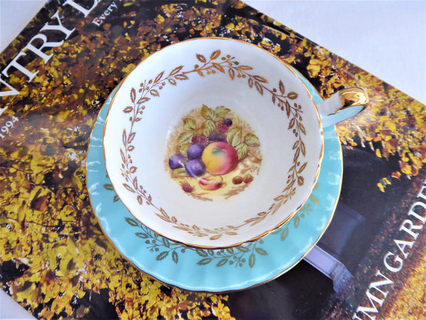 Aynsley Turquoise Cup And Saucer Fruit Center Gold Overlay