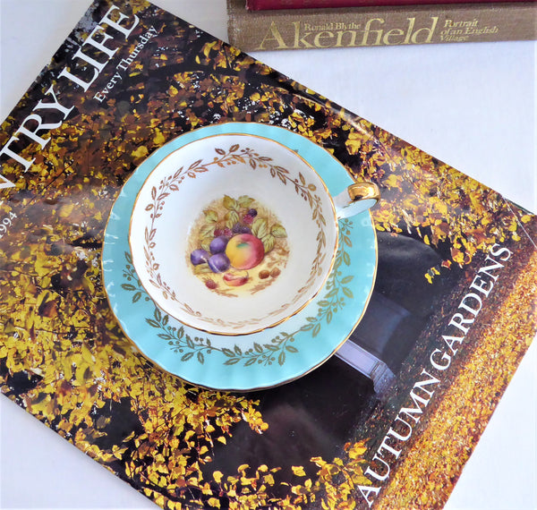 Aynsley Turquoise Cup And Saucer Fruit Center Gold Overlay