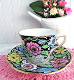 Dramatic Rosina Floral Cup And Saucer Hand Colored 1930s Black and Chintz Bands