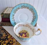 Aynsley Turquoise Cup And Saucer Fruit Center Gold Overlay 1940s