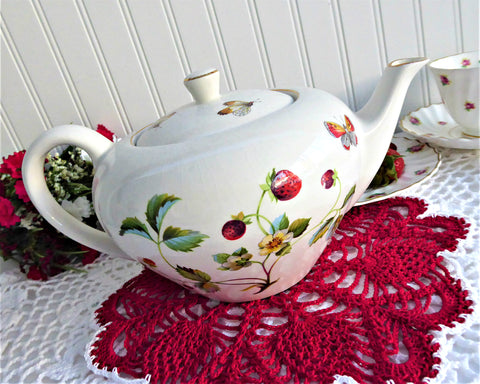 https://www.antiquesandteacups.com/cdn/shop/products/1950s-JamesKent-teapot-Strawberry-butterflies-large-a_large.jpg?v=1656864369