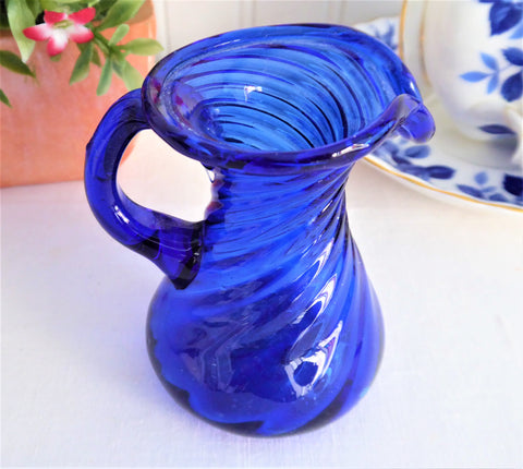 https://www.antiquesandteacups.com/cdn/shop/products/1980s-cobalt-blue-glass-pitcher-blown-c_large.jpg?v=1652968460